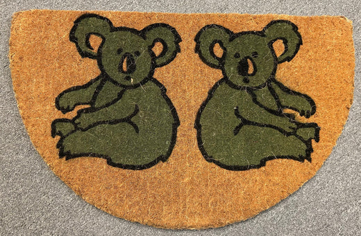 Doormat with green bear illustrations on a textured surface
